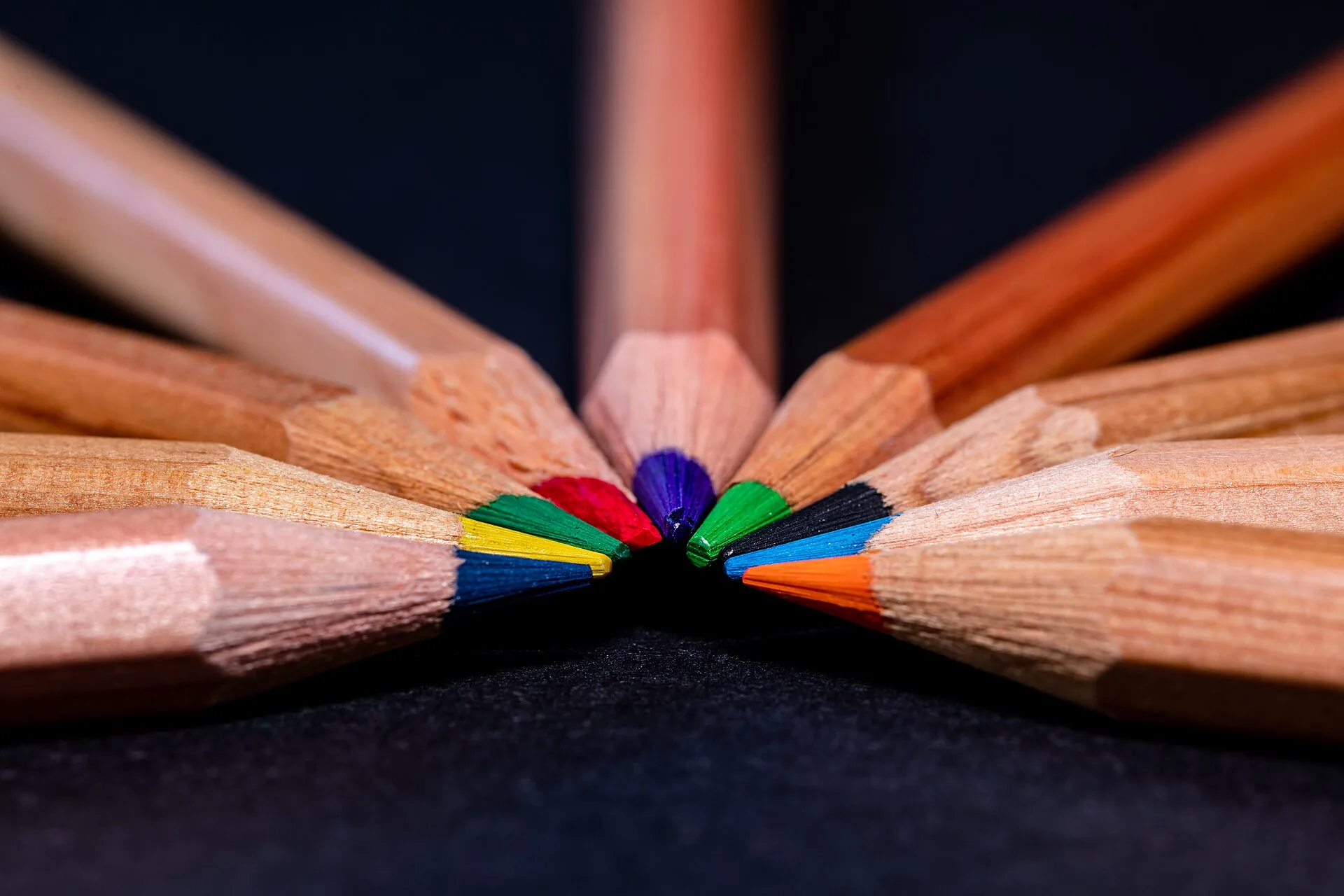 Coloured pencils arranged in a fan, tips meeting in the centre