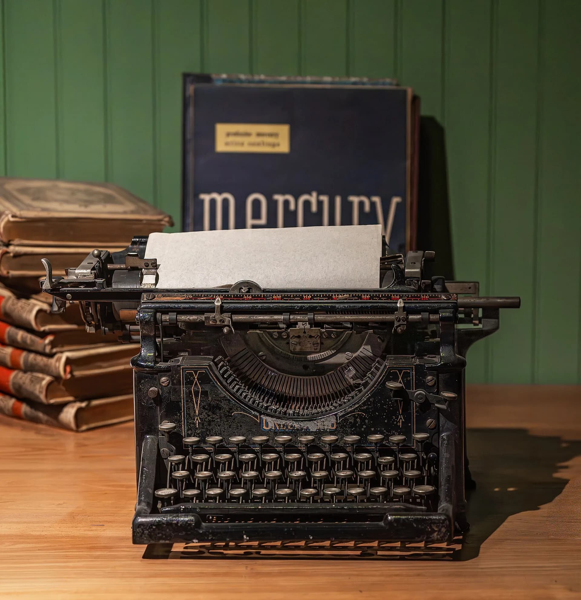 Antique typewriter on a desk in front of old books